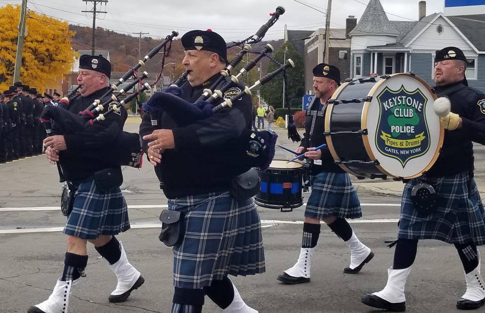 The Keystone Club Police Pipes and Drums corps from Gates leads a procession to the ceremony. They played “Amazing Grace” as the monument to Sgt. Daniel J. Swift was unveiled Oct. 28, 2023 in Union Square Park in Hornell.