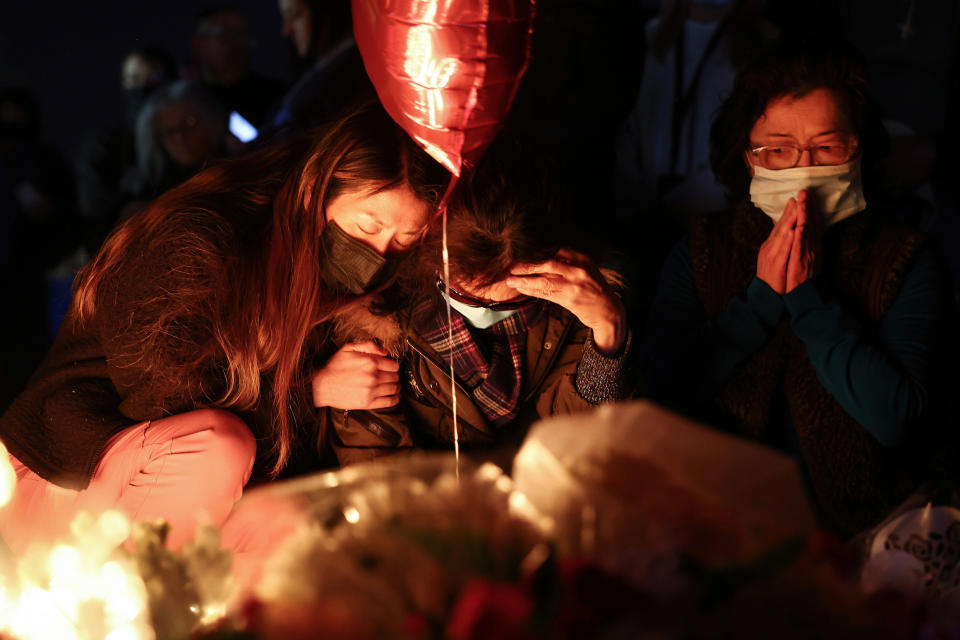 People gather at a candlelight vigil   for victims of a  mass shooting at a ballroom dance studio in Monterey Park, Calif. (Mario Tama / Getty Images)