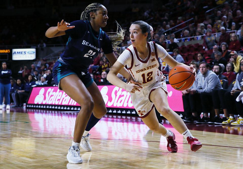 Iowa State Cyclones guard Mary Kate King (12) drives around UNC Wilmington Seahawks guard Kylah Silver (21) during the fourth quarter at Hilton Coliseum on Sunday, Dec.3. 2023, in Ames, Iowa.