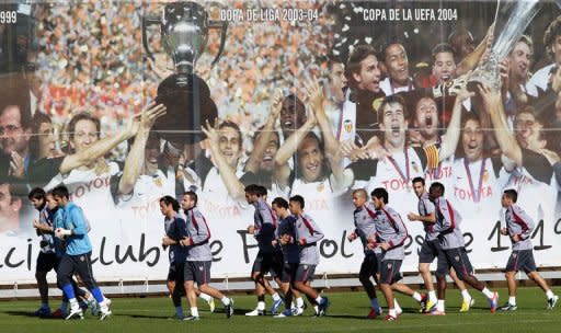 Valencia's players warm up during a training session at Paterna's Sport City, near Valencia, on the eve of the UEFA Champions League football match between Valencia CF and FC Bayern Munich