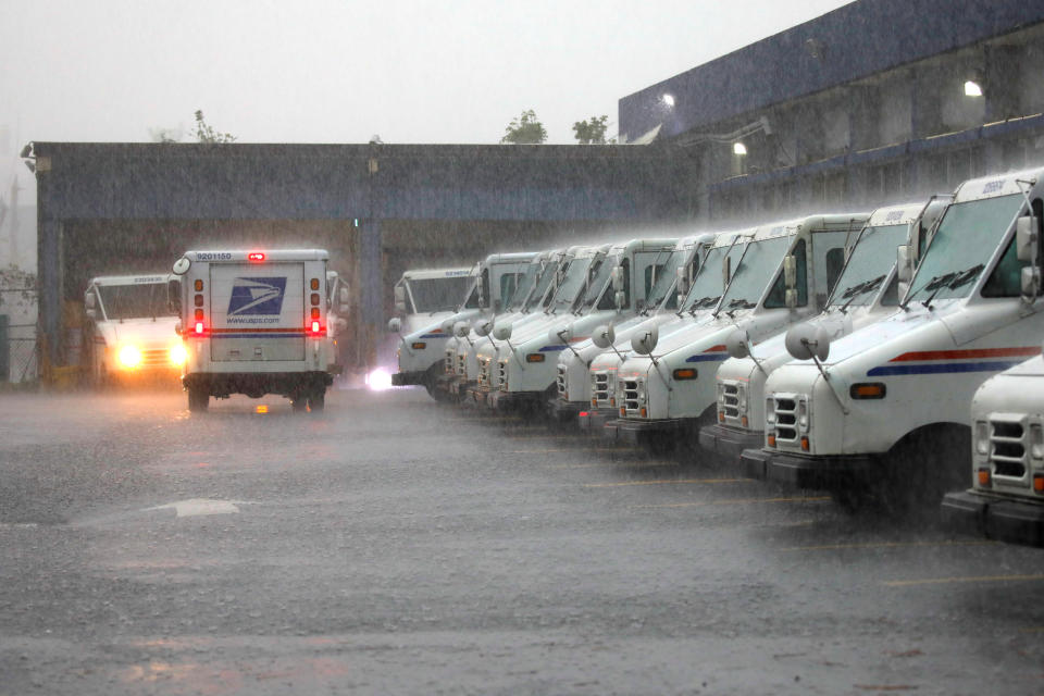 <p>U.S. Postal Service trucks are seen under heavy rain, weeks after Hurricane Maria hit Puerto Rico, in San Juan, Puerto Rico, Oct. 6, 2017. (Photo: Carlos Barria/Reuters) </p>