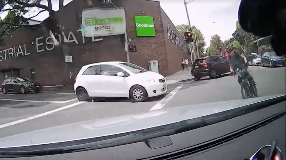 The rider can be seen swerving around car into the path of the dash cam filmer. Source: Facebook / Dash Cam Owners Australia