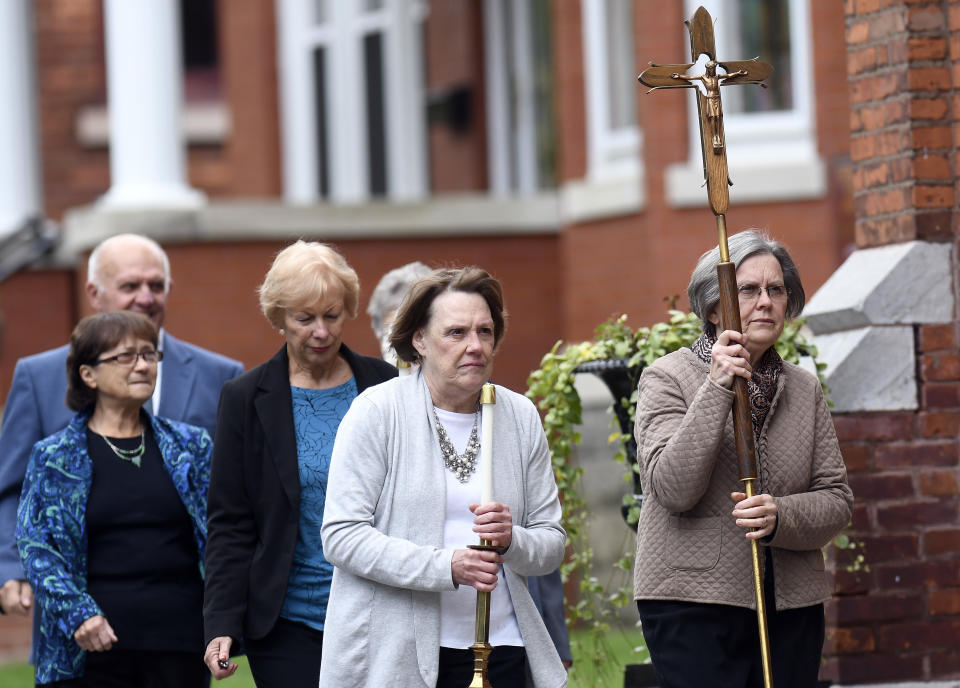 Friends and family arrive before the start of a funeral Mass for eight of the 20 people killed in last Saturday's fatal limousine crash in Schoharie, N.Y., during a memorial service at St. Stanislaus Roman Catholic Church in Amsterdam, N.Y., Saturday, Oct. 13, 2018. (AP Photo/Hans Pennink)