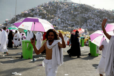 A Muslim pilgrim from Syria gestures as he gather with others on Mount Mercy on the plains of Arafat during the annual haj pilgrimage, outside the holy city of Mecca, Saudi Arabia August 20, 2018. REUTERS/Zohra Bensemra