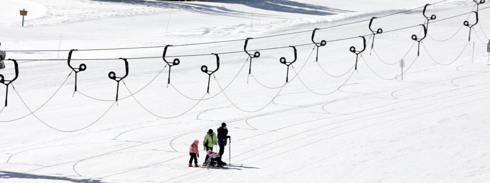 FILE - In this Feb. 19, 2013, file photo, skiers take the slopes at Alta Ski Resort in Little Cottonwood Canyon near Salt Lake City. Attorneys for the U.S. Forest Service say in court arguments filed this week that the decision by the Alta ski area in Utah to promote a snowboarder-free experience to lure skiers is a rational finding that violates no constitutional rights. Four snowboarders filed the lawsuit in federal court in January. They're claiming discrimination on national forest lands that make up most of the Alta ski area in the mountains east of Salt Lake City. (AP Photo/The Deseret News, Jeffrey D. Allred, File) ) SALT LAKE TRIBUNE OUT, MAGS OUT, MANDATORY CREDIT.