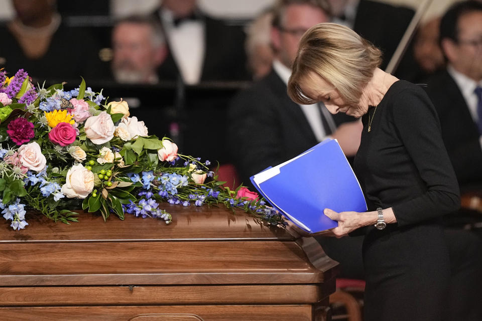 Journalist Judy Woodruff pauses at the casket of first lady Rosalynn Carter, after speaking at a tribute service at the Glenn Memorial Church, in Atlanta, Tuesday, Nov. 28, 2023. Woodruff recalled Rosalynn Carter lobbying lawmakers, campaigning separately from her husband, attending Cabinet meetings and playing key roles. (AP Photo/Brynn Anderson)