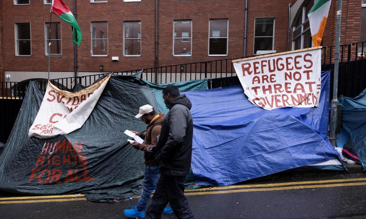 <span>Asylum seekers outside the International Protection Office, in Dublin.</span><span>Photograph: Clodagh Kilcoyne/Reuters</span>