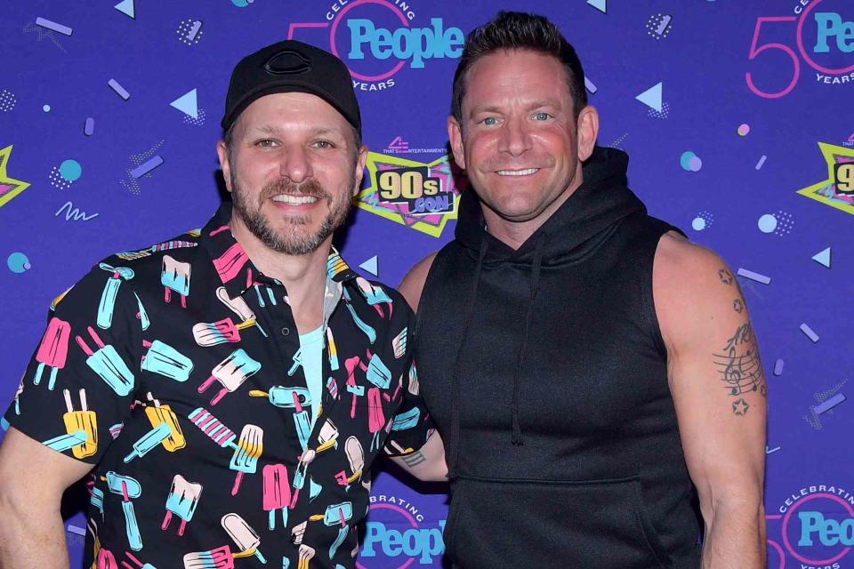 <p>Stephen Lovekin/ Shutterstock</p> Drew Lachey (left) and Jeff Timmons pose at 90s Con