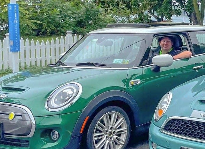 Gerry Goris, of Buffalo, New York, sits in his 2020 Mini Cooper SE all-electric car, which he traded in for a new 2023 Mini Cooper SE, with some encouragement from Mini USA which is looking to beef up its fleet of used EVs.