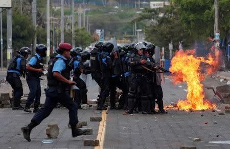 A petrol bomb explodes near riot policemen during clashes with university students protesting over a controversial reform to the pension plans of the Nicaraguan Social Security Institute (INSS) in Managua, Nicaragua April 20, 2018. REUTERS/Oswaldo Rivas