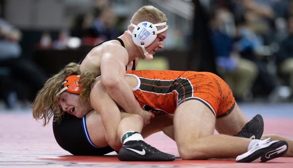 Columbus East's Tommy Morrill, below, wrestles Evansville Reitz Memorial's Kelton Farmer during the semifinals of the Evansville Semistate wrestling tournament at the Ford Center in Evansville, Ind., Saturday afternoon, Feb. 12, 2022.