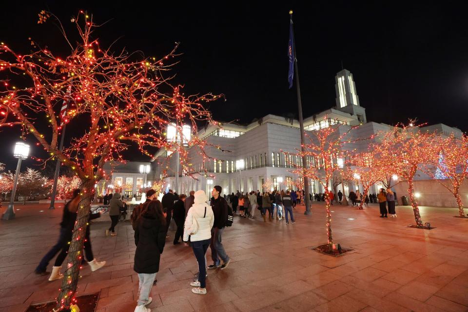 Atendees walk to see The Tabernacle Choir at Temple Square and Orchestra at Temple Square perform during their annual Christmas Concerts at the Conference Center in Salt Lake City on Thursday, Dec. 14, 2023. | Jeffrey D. Allred, Deseret News