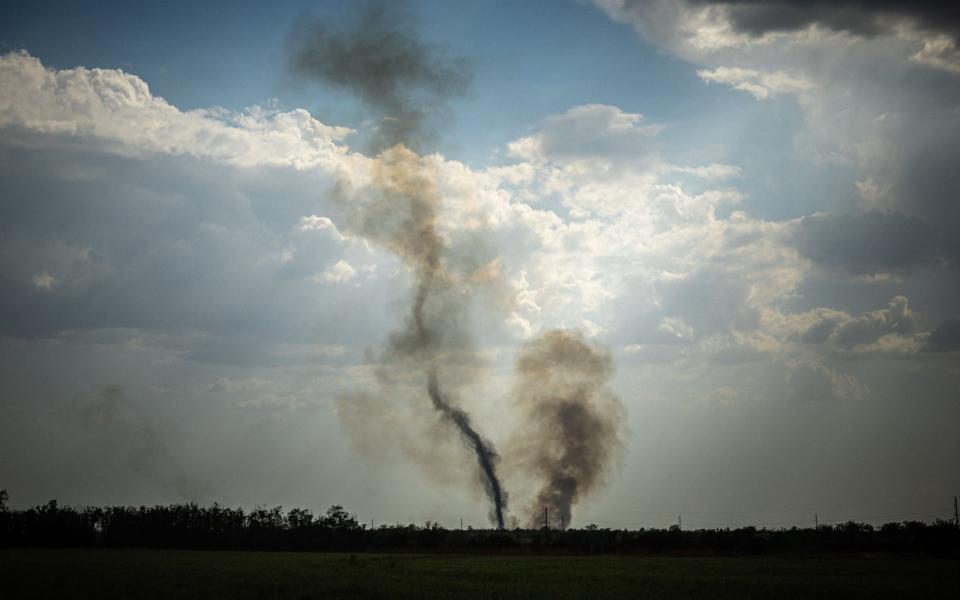 Black smoke rises at the front line in Mykolaiv Oblast  - DIMITAR DILKOFF/AFP 