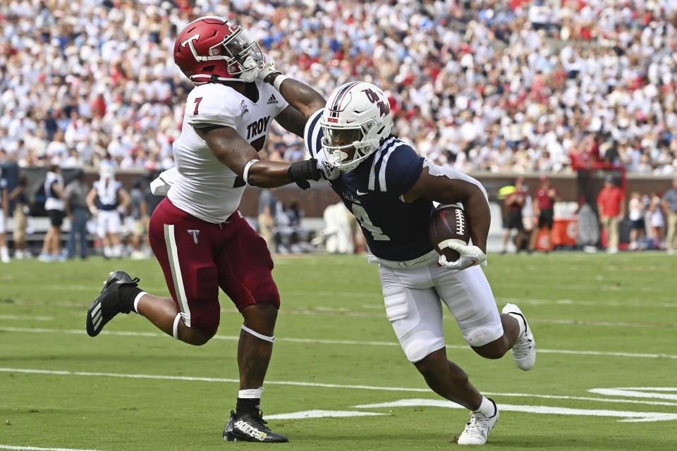 Troy linebacker KJ Robertson (7) tackles Mississippi running back Quinshon Judkins (4) during the first half an NCAA college football game in Oxford, Miss., Saturday, Sept. 3, 2022. (AP Photo/Thomas Graning)