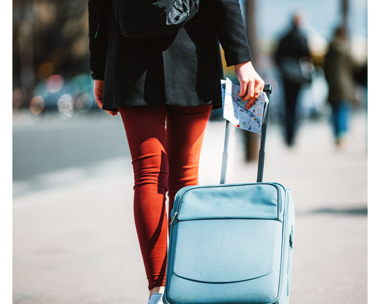 Woman pulling a rolling suitcase