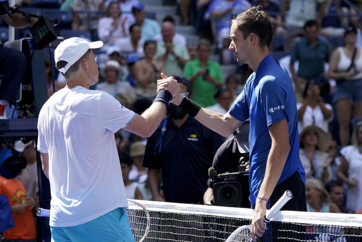 Daniil Medvedev, of Russia, right, shakes hands with Stefan Kozlov, of the United States, after winning their first-round match of the U.S. Open tennis championships, Monday, Aug. 29, 2022, in New York.