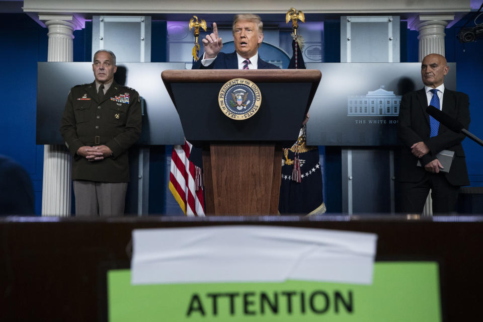 President Donald Trump speaks during a news conference in the James Brady Press Briefing Room of the White House, Friday, Sept. 18, 2020, in Washington, as Army Gen. Gustave Perna, who is leading Operation Warp Speed, and Dr. Moncef Slaoui, chief adviser to Operation Warp Speed, listen. (AP Photo/Alex Brandon)