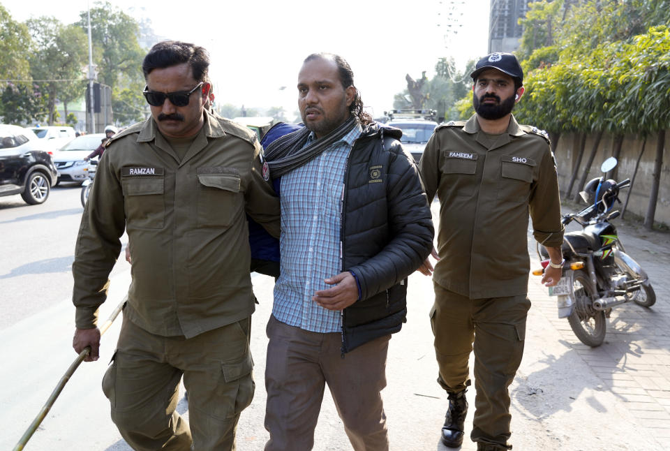 Security personnel detain a supporter of Pakistan's Former Prime Minister Imran Khan's during a protest against the delaying result of parliamentary election by Pakistan Election Commission, in Lahore, Pakistan, Sunday, Feb. 11, 2024. (AP Photo/K.M. Chaudary)