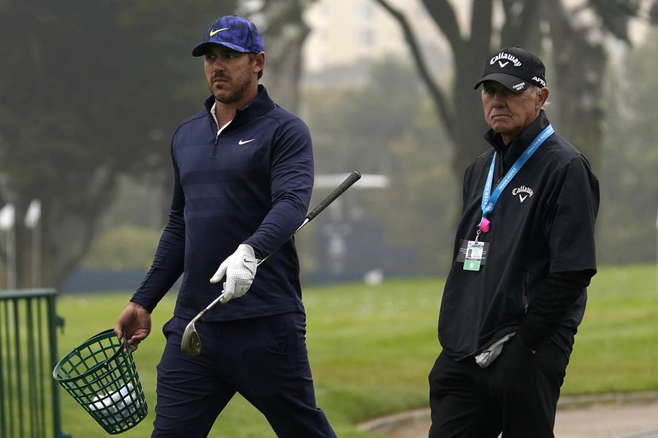 Brooks Koepka, left, walks with instructor Pete Cowen during practice for the PGA Championship golf tournament at TPC Harding Park in San Francisco, Tuesday, Aug. 4, 2020. (AP Photo/Jeff Chiu)