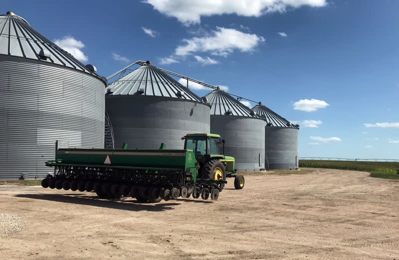 Grain bins are seen in front of crops at Knuth Farms in Mead, Nebraska