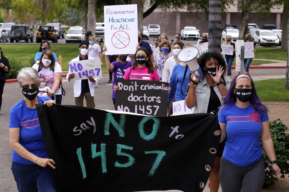 A number of Arizona reproductive rights groups march to deliver a petition to Gov. Doug Ducey to veto SB 1457, the latest abortion bill passed by the state legislature last week, at the Arizona Capitol Monday, April 26, 2021, in Phoenix. (AP Photo/Ross D. Franklin)