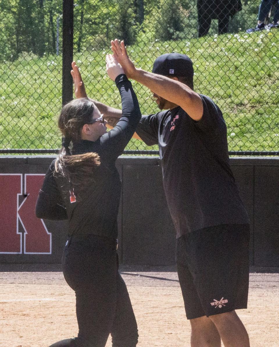 White Plains coach Chris Rowan high-fives Alexis Tighe during the Tigers' win over Albertus Magnus in the Nyack Red and Black Tournament finale.