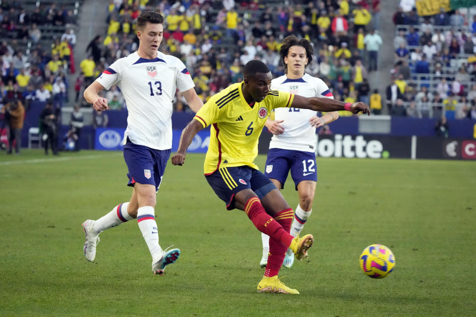Colombia's Juan David Mosquera (6) takes a shot on goal past United States' Matthew Hoppe (13) during the first half of an international friendly soccer match Saturday, Jan. 28, 2023, in Carson, Calif. (AP Photo/Marcio Jose Sanchez)