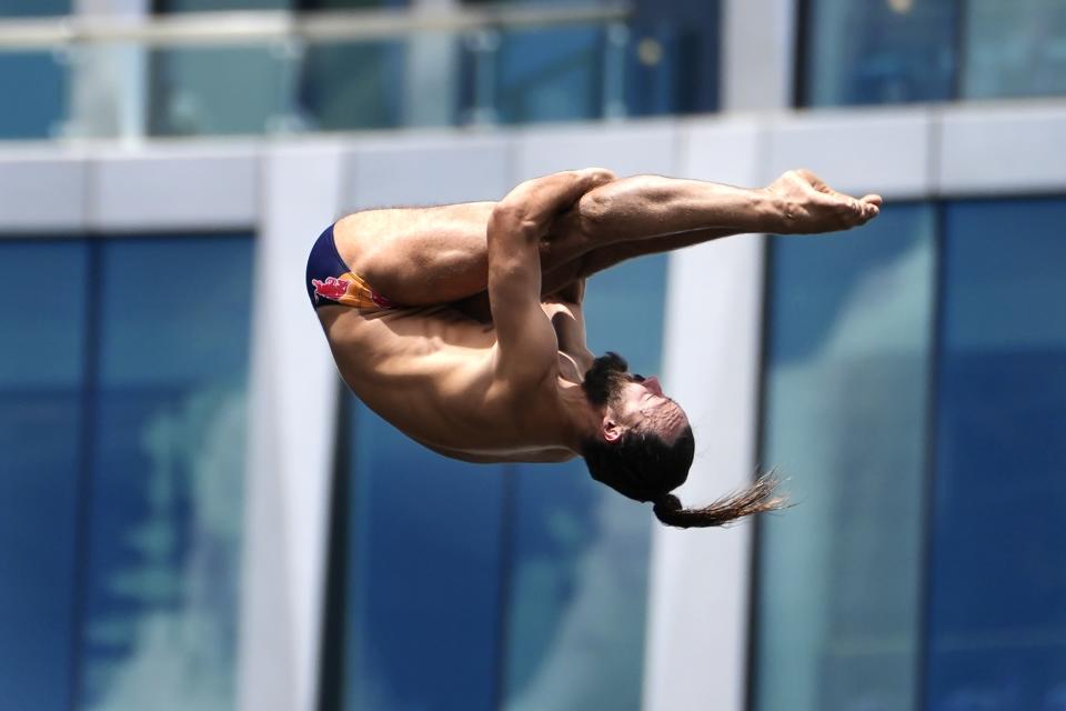 Catalin Preda, of Romania, takes a practice dive during which he was injured in the Red Bull Cliff Diving World Series, Saturday, June 8, 2024, in Boston. (AP Photo/Michael Dwyer)