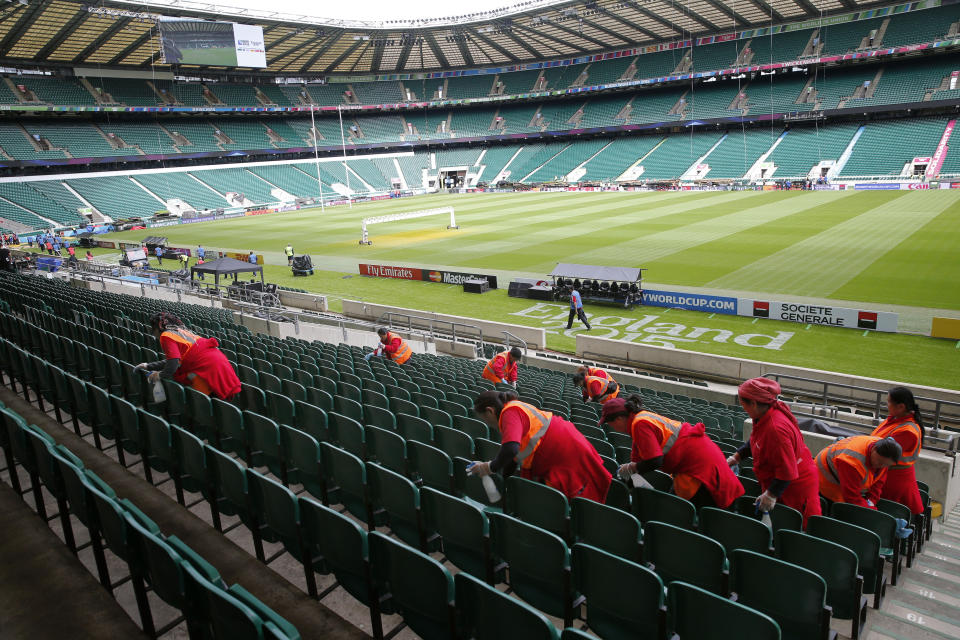 FILE - In this Sept. 15, 2015, file photo, workers clean the seats at Twickenham Stadium, London, prior to the start of the Rugby World Cup. (AP Photo/Christophe Ena, File)