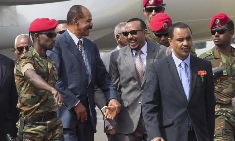 Isaias, centre left, and Ethiopia’s president, Abiy Ahmed, centre, greet each other at the airport.