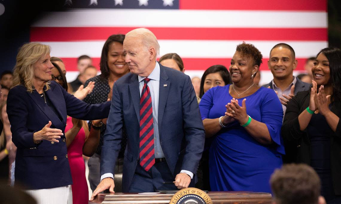 President Joe Biden turns to face First Lady Jill Biden after signing an executive order to support military and veteran communities. Biden spoke at an event at Fort Liberty in Fayetteville, N.C. on Friday, June 9, 2023.