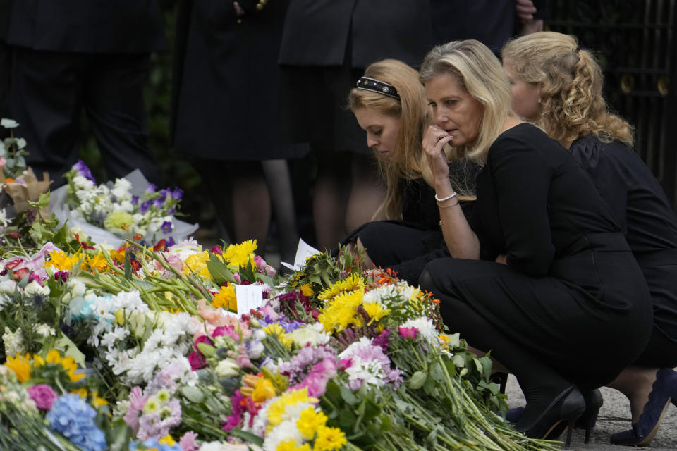 Sophie, Countess of Wessex, looks at the flowers laid outside the gates of Balmoral Castle in Aberdeenshire, Scotland Saturday, Sept. 10, 2022, along with other members of the British Royal family. Queen Elizabeth II, Britain's longest-reigning monarch and a rock of stability across much of a turbulent century, died Thursday after 70 years on the throne. She was 96. (AP Photo/Alastair Grant)