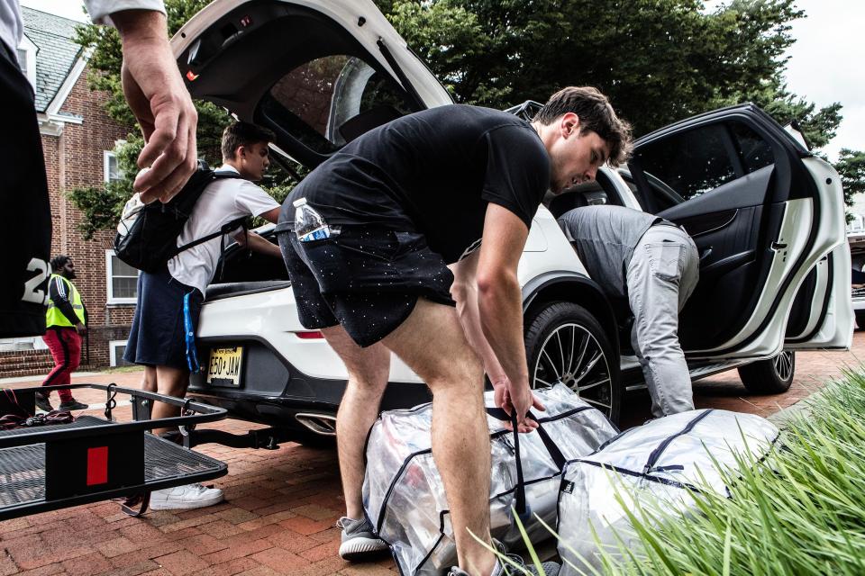 First-year student Matt Barreira, at left, unpacks the car trunk and is assisted by his family during his move to campus at the University of Delaware's South Academy Hall in Newark, Friday, Aug. 25, 2023. More than 4,000 first-year students will arrive on campus for Move-in Weekend and the start of the 2023-2024 academic year.