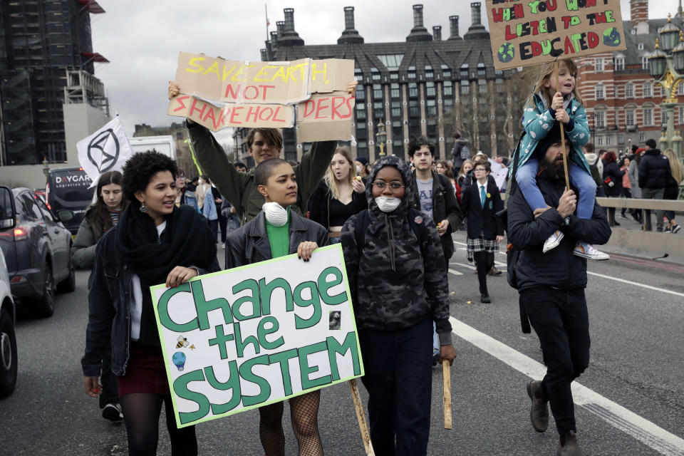 Youngsters march across Westminster Bridge take part in a student climate protest in London, Friday, March 15, 2019. Students in more than 80 countries and territories worldwide plan to skip class Friday in protest over their governments' failure to act against global warming. The coordinated 'school strike' was inspired by 16-year-old activist Greta Thunberg, who began holding solitary demonstrations outside the Swedish parliament last year. (AP Photo/Matt Dunham)