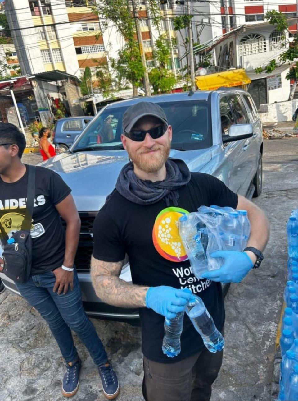 Jacob Flickinger posing while holding water bottles to distribute in Mexico (Jonathan Duguay)