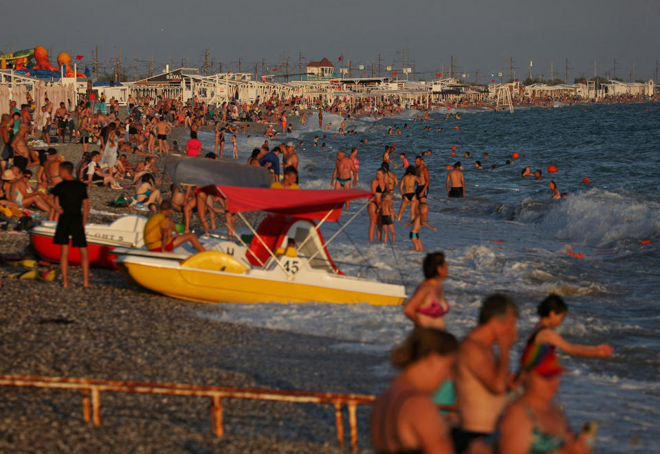 People enjoy the beach during sunset in Yevpatoriya, Crimea, on Aug. 6.