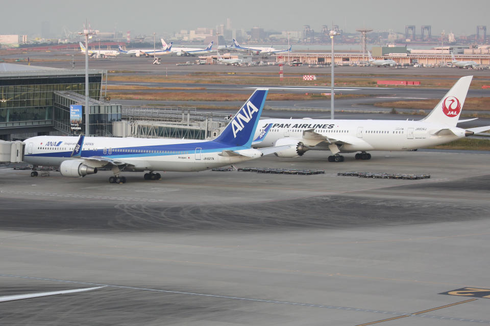 Airplanes sit on the tarmac at Haneda international airport in Tokyo, Monday, Nov. 29, 2021. As cases of a new coronavirus variant are confirmed around the world, Japan announced Monday that it will suspend entry of all foreign visitors, joining an increasing number of countries that are tightening their borders as fear spreads of yet another extension of pandemic suffering. (AP Photo/Koji Sasahara)