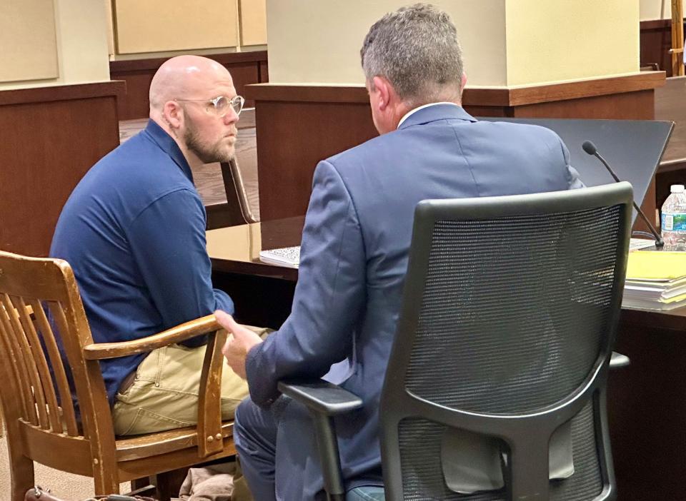 Steven Yinger, on trial for first-degree murder in the 2022 killing of Jorge Diaz Johnston, speaks with his attorney, Zachary Ward, before opening statements on Wednesday, Dec. 13, 2023.