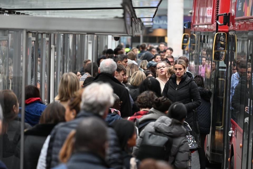 People struggling to board a bus at Victoria station (Jeremy Selwyn)