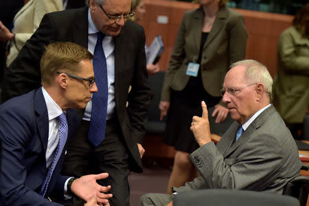 Finland's Finance Minister Alexander Stubb (L) listens to his German counterpart Wolfgang Schaeuble during a Euro zone finance ministers meeting, to discuss whether Greece has passed sufficient reforms to unblock new loans and how international lenders might grant Athens debt relief, in Brussels, Belgium May 24, 2016. REUTERS/Eric Vidal