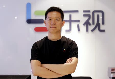 Jia Yueting, co-founder and head of Le Holdings Co Ltd, also known as LeEco and formerly as LeTV, poses for a photo in front of a logo of his company after a Reuters interview at LeEco headquarters in Beijing, China, picture taken April 22, 2016. REUTERS/Jason Lee