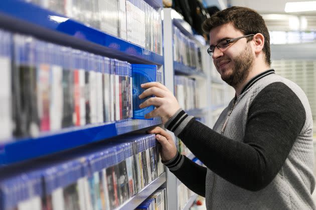 A happy man, selecting a DVD at a video store, not yet aware of the shame he will soon endure. (Photo: Matic Grmek via Getty Images)