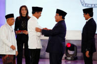 Indonesia's presidential candidate Joko Widodo shakes hands with his opponent Prabowo Subianto as their running mates Ma'ruf Amin and Sandiaga Uno smile after a televised debate in Jakarta, Indonesia January 17, 2019. REUTERS/Willy Kurniawan