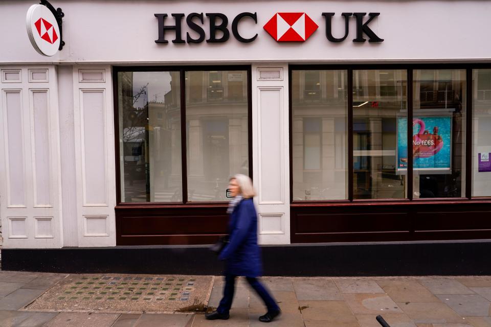 A person walks past an HSBC branch, in London, Monday, March 13, 2023. Governments in the UK and U.S. took extraordinary steps to stop a potential banking crisis after the historic failure of Silicon Valley Bank, even as another major bank was shut down. The UK Treasury and the Bank of England “facilitated the sale″ of Silicon Valley Bank UK to HSBC, ensuring the security of 6.7 billion pounds ($8.1 billion) of deposits. (AP Photo/Alberto Pezzali)