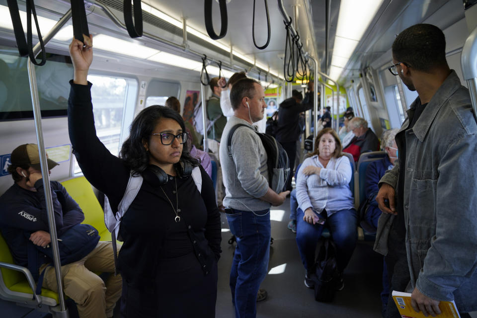 Sadaf Zahoor, left, rides in a Bay Area Rapid Transit train Wednesday, June 7, 2023, in Oakland, Calif. Zahoor has used public transit her whole life and relies on it to get to work. (AP Photo/Godofredo A. Vásquez)