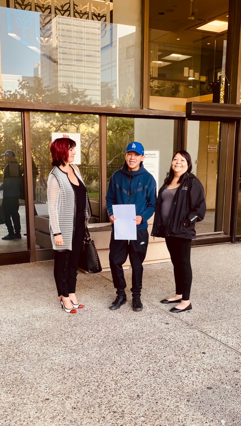 Lawyer Heather Steinke-Attia with Pacey Dumas and Irene Dumas outside the Edmonton courthouse Monday after taking the first step aimed at privately prosecuting Const. Ben Todd. (Submitted by Heather Steinke-Attia - image credit)