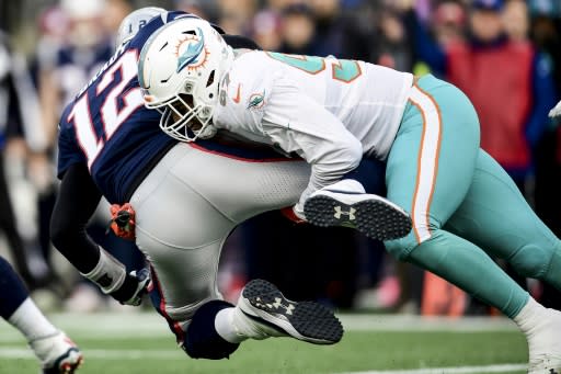 Shocker: New England quarterback Tom Brady is sacked by Miami's Trent Harris in the Dolphins' upset win over the Patriots on the final day of the 2019 NFL regular season