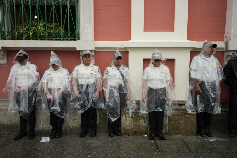 Police stand guard outside the Electoral Court building as demonstrators march to support the electoral process in Guatemala City, on a rainy Saturday, July 8, 2023. Chief Justice Silvia Valdes Quezada issued an order blocking the certification of the results for the first-round presidential June 25th election, late Friday. (AP Photo/Moises Castillo)