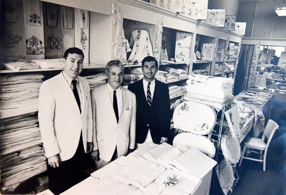 The late Sam Kassatly. who founded the family's luxury linen business, in 1923, is flanked by sons Ed, left, and Bob, in a photograph taken at the family's Worth Avenue shop in the early 1960s.