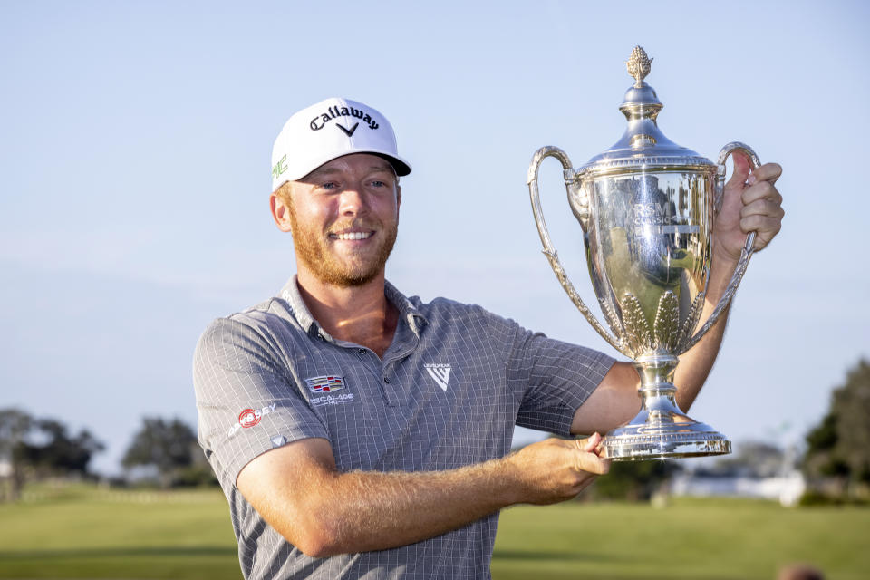 Talor Gooch holds the championship trophy after the final round of the RSM Classic golf tournament, Sunday, Nov. 21, 2021, in St. Simons Island, Ga. (AP Photo/Stephen B. Morton)